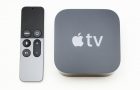 Paris, France - November 10, 2015: New Apple TV media streaming  player microconsole by Apple Computers next to the new touch remote swipe-to-select with integrated Siri and motion sensor on white
