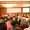 Rear view of many listeners sitting on chairs during lecture at conference